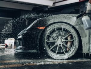 A professional detailing a car in his newly opened shop