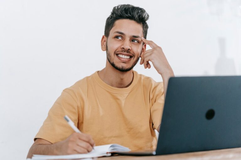 A man writing a business plan for his auto detailing business