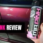 mr pink review with bottle held beside clean car